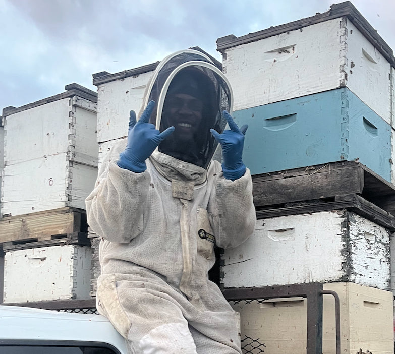 Maj, head beekeeper at Timber Creek Bees, with the hives
